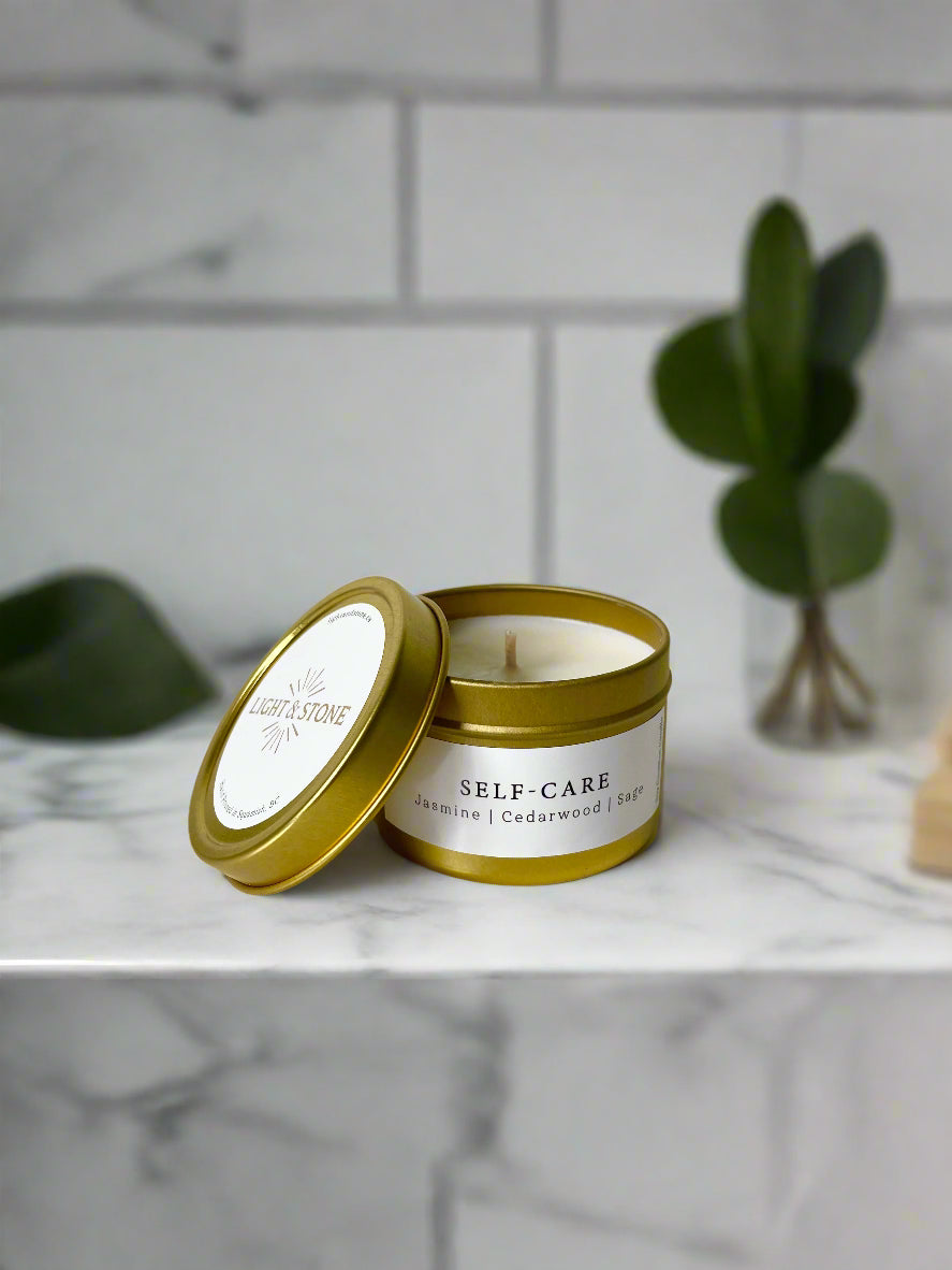 Scented candle in gold tin with lid off