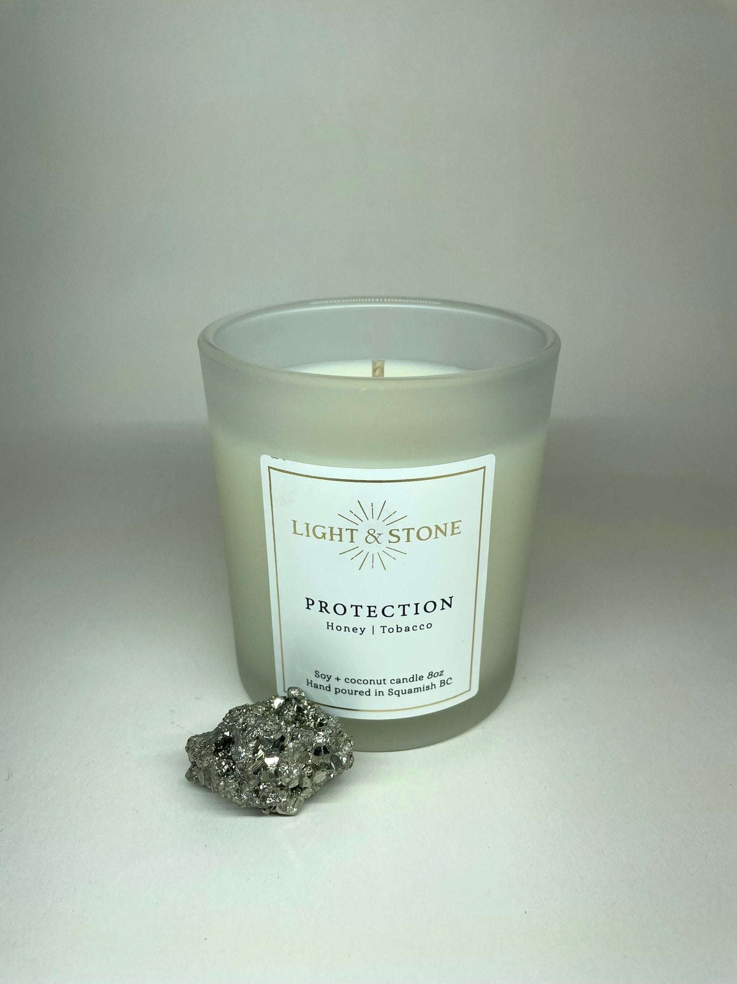 non toxic scented candle in frosted glass honey tobacco with pyrite crystal